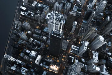 Aerial night view of a city's illuminated skyline